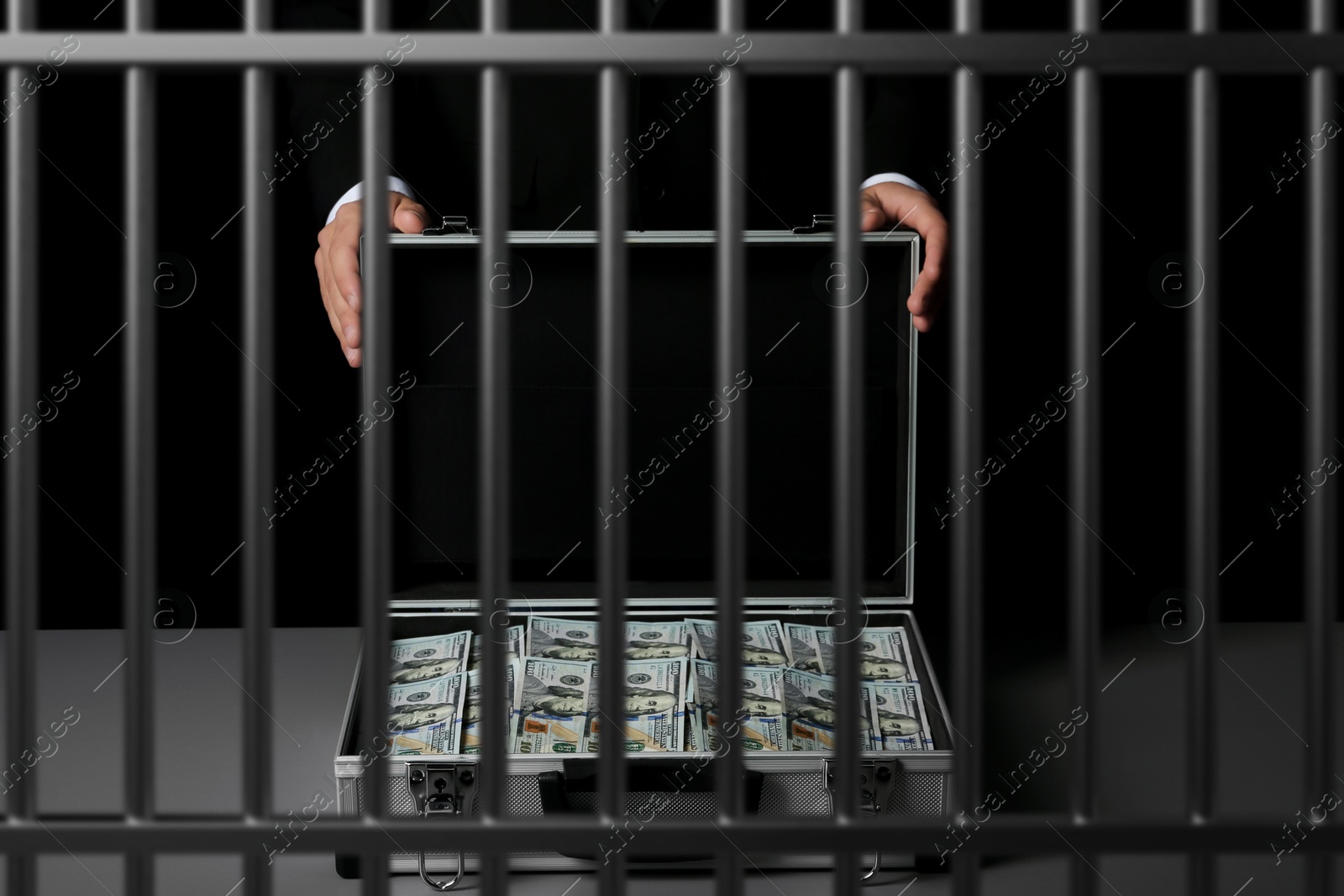 Stop corruption. Man with suitcase full of money in jail, closeup. Imprisonment for bribery Image of Stop corruption. Man with suitcase full of money in jail, closeup. Imprisonment for bribery