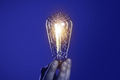Illustration of Man holding glowing light bulb with pattern of connected dots on blue gradient background. Idea, creativity, innovation