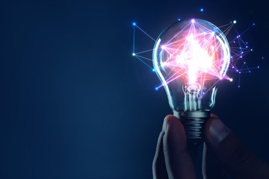 Illustration of Man holding light bulb with pattern of connected dots on blue gradient background. Idea, creativity, innovation