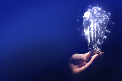 Illustration of Man holding light bulb with pattern of connected dots on blue gradient background. Idea, creativity, innovation