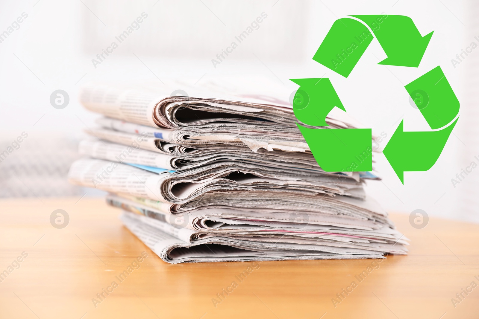 Recycling symbol and stack of many newspapers on wooden table, closeup. Eco-friendly lifestyle, reusing Image of Recycling symbol and stack of many newspapers on wooden table, closeup. Eco-friendly lifestyle, reusing