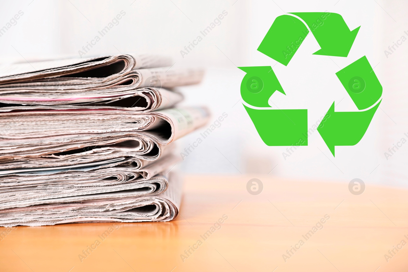 Recycling symbol and stack of many newspapers on wooden table, closeup. Eco-friendly lifestyle, reusing Image of Recycling symbol and stack of many newspapers on wooden table, closeup. Eco-friendly lifestyle, reusing