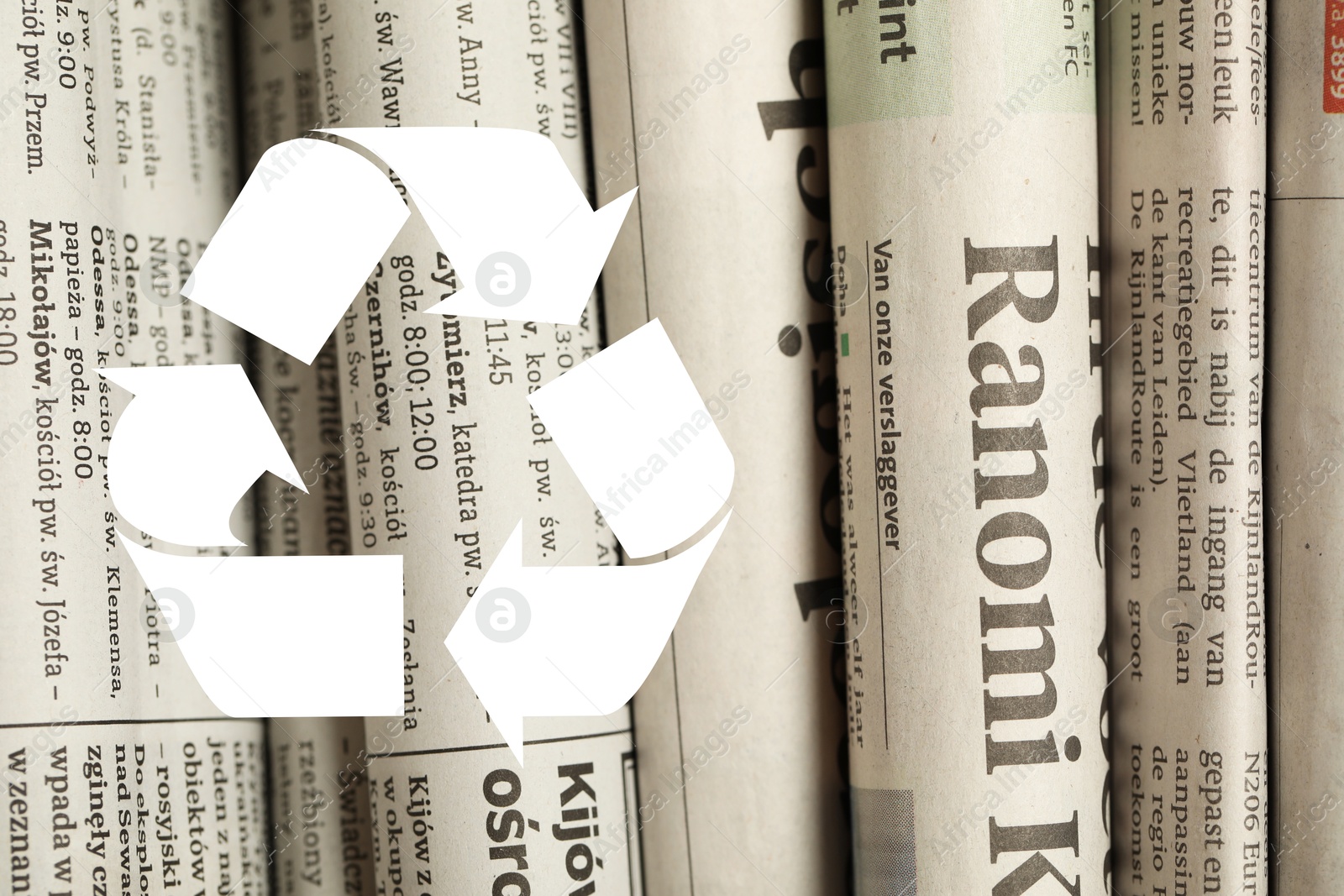 Recycling symbol and many newspapers in different languages as background, closeup. Eco-friendly lifestyle, reusing Image of Recycling symbol and many newspapers in different languages as background, closeup. Eco-friendly lifestyle, reusing