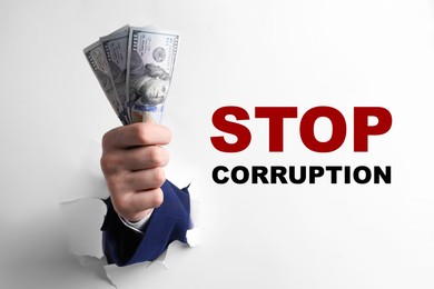 Image of Stop corruption. Businessman breaking through white paper with money in hand, closeup