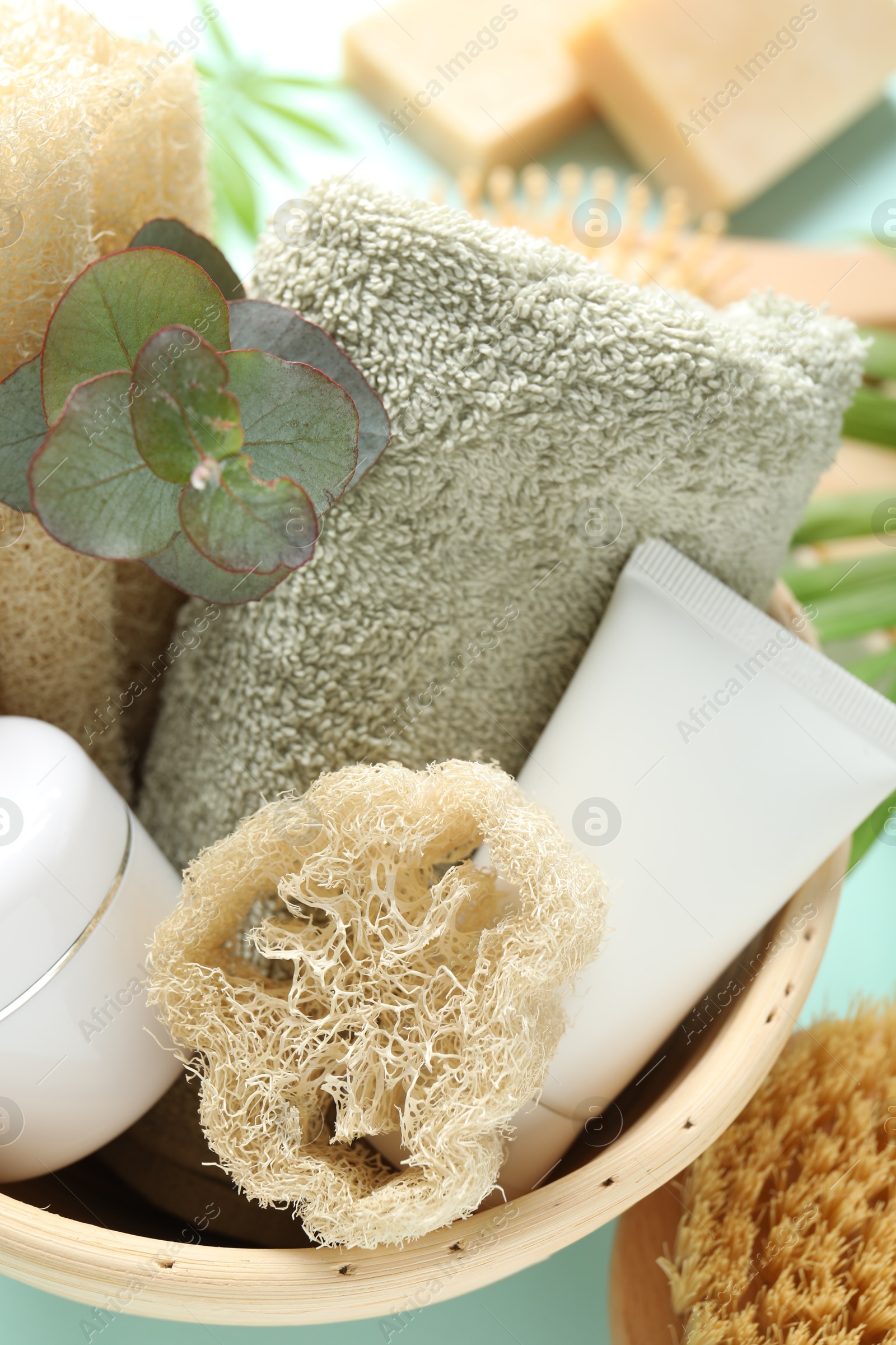 Loofah sponges, cosmetic products, towel and floral decor on table, above view Photo of Loofah sponges, cosmetic products, towel and floral decor on table, above view