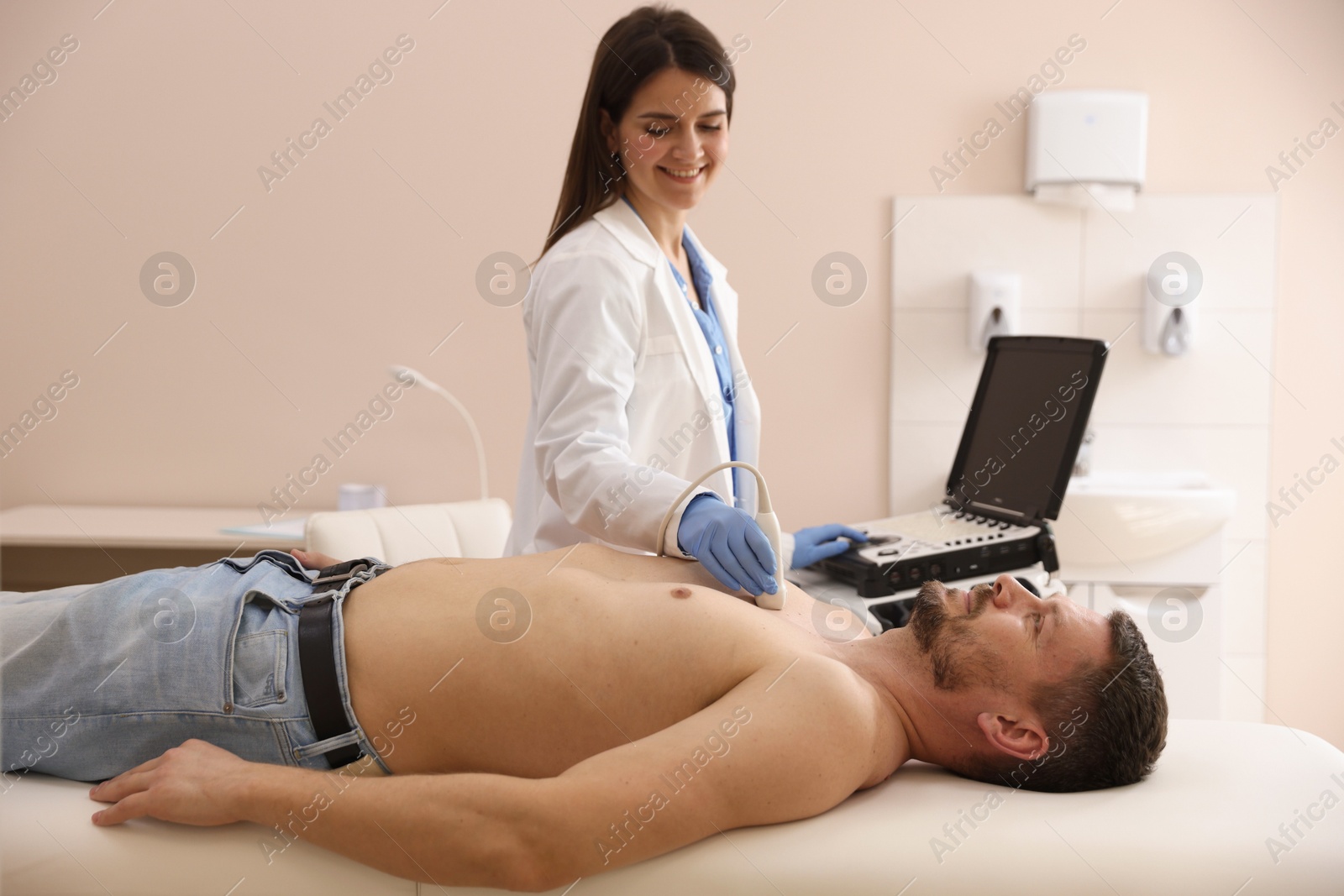 Sonographer conducting ultrasound examination of man's heart in clinic Photo of Sonographer conducting ultrasound examination of man's heart in clinic