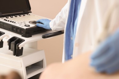 Photo of Sonographer conducting ultrasound examination of man's heart in clinic, closeup