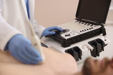 Photo of Sonographer conducting ultrasound examination of man's heart in clinic, closeup