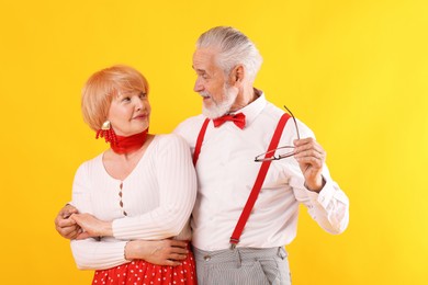 Photo of Lovely senior couple together on yellow background