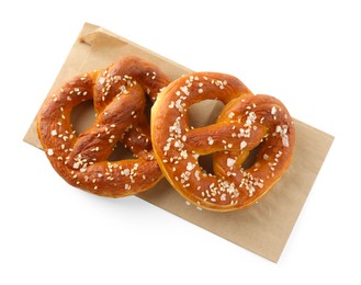 Photo of Tasty pretzels with salt isolated on white, top view