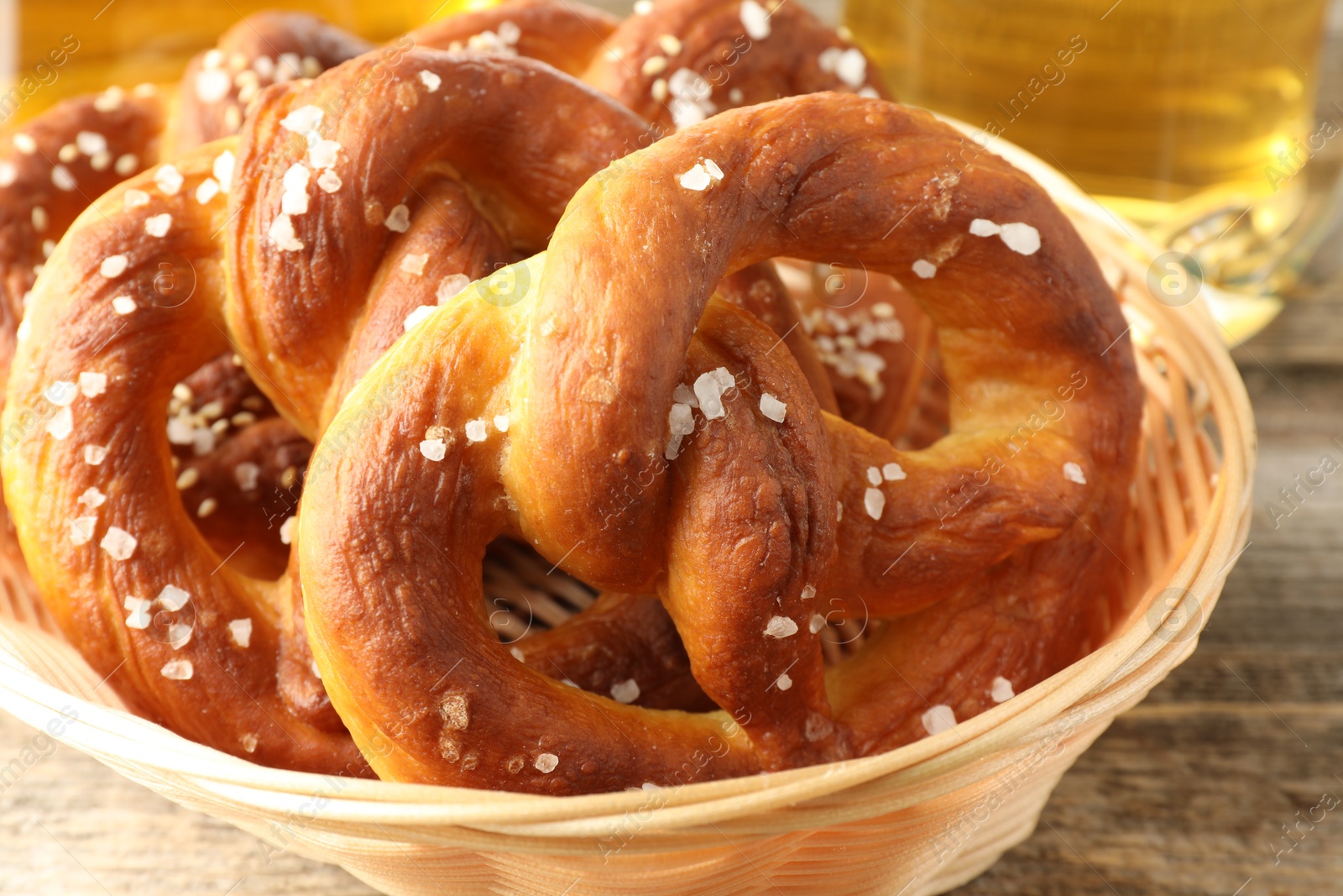 Tasty pretzels in basket on wooden table, closeup Photo of Tasty pretzels in basket on wooden table, closeup