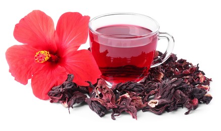 Photo of Delicious hibiscus tea in glass cup, dry roselle sepals and beautiful flower isolated on white