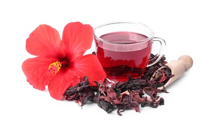 Photo of Delicious hibiscus tea in glass cup, dry roselle sepals and beautiful flower isolated on white