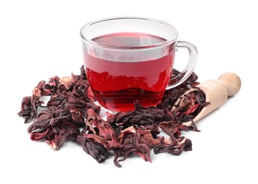 Photo of Delicious hibiscus tea in glass cup, dry roselle sepals and beautiful flower isolated on white
