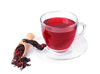 Photo of Delicious hibiscus tea in glass cup, dry roselle sepals and scoop isolated on white