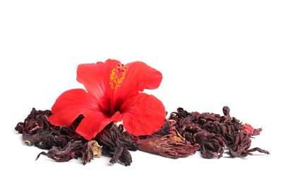 Photo of Hibiscus tea. Dried roselle sepals and beautiful flower isolated on white