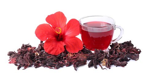 Photo of Delicious hibiscus tea in glass cup, dry roselle sepals and beautiful flower isolated on white