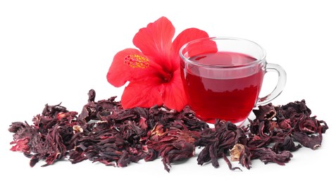 Photo of Delicious hibiscus tea in glass cup, dry roselle sepals and beautiful flower isolated on white