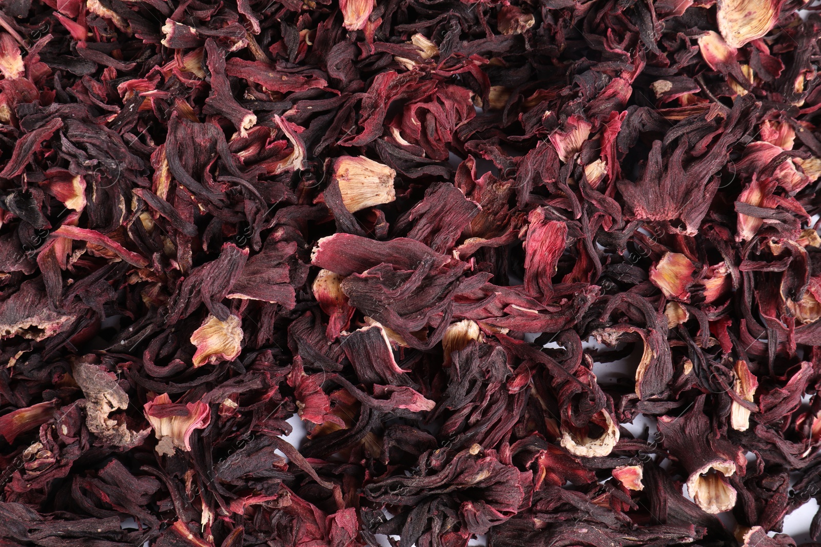 Hibiscus tea. Dried roselle sepals as background, top view Photo of Hibiscus tea. Dried roselle sepals as background, top view