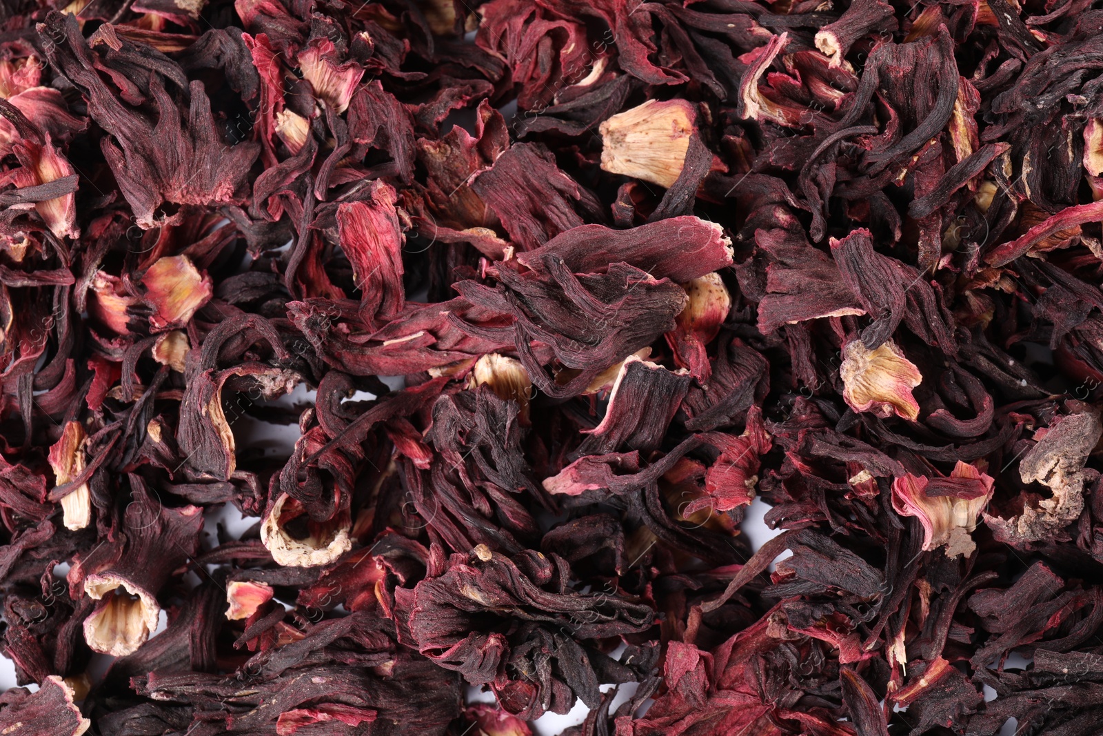 Hibiscus tea. Dried roselle sepals as background, top view Photo of Hibiscus tea. Dried roselle sepals as background, top view