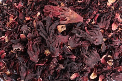 Photo of Hibiscus tea. Dried roselle sepals as background, top view