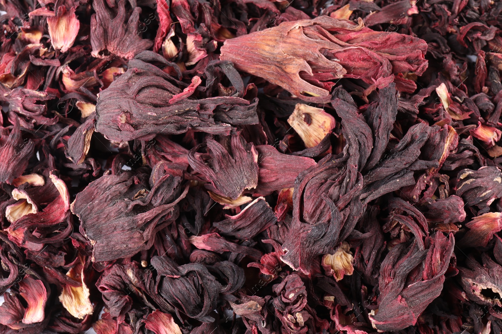 Hibiscus tea. Dried roselle sepals as background, top view Photo of Hibiscus tea. Dried roselle sepals as background, top view