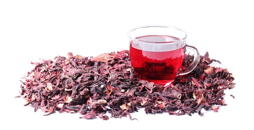 Photo of Delicious hibiscus tea in glass cup and dry roselle sepals isolated on white