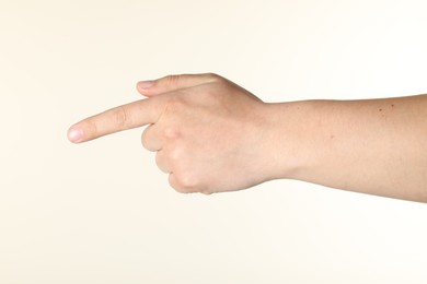 Photo of Man holding something in hand on beige background, closeup