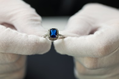 Photo of Appraiser working with luxury ring at table, closeup