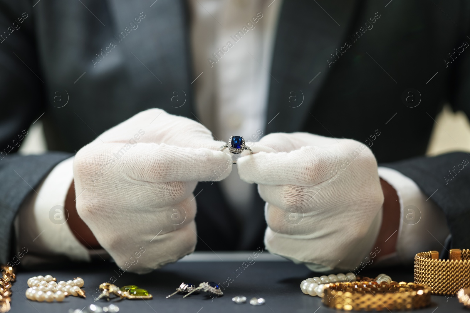 Appraiser working with luxury ring at table, closeup Photo of Appraiser working with luxury ring at table, closeup