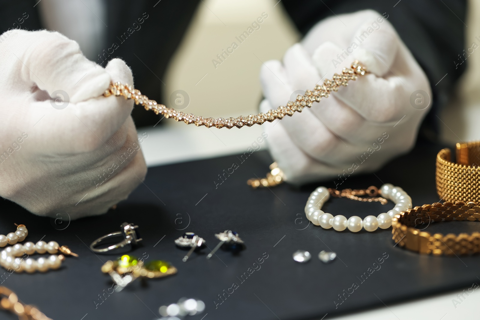 Appraiser working with luxury jewelry at table indoors, closeup Photo of Appraiser working with luxury jewelry at table indoors, closeup