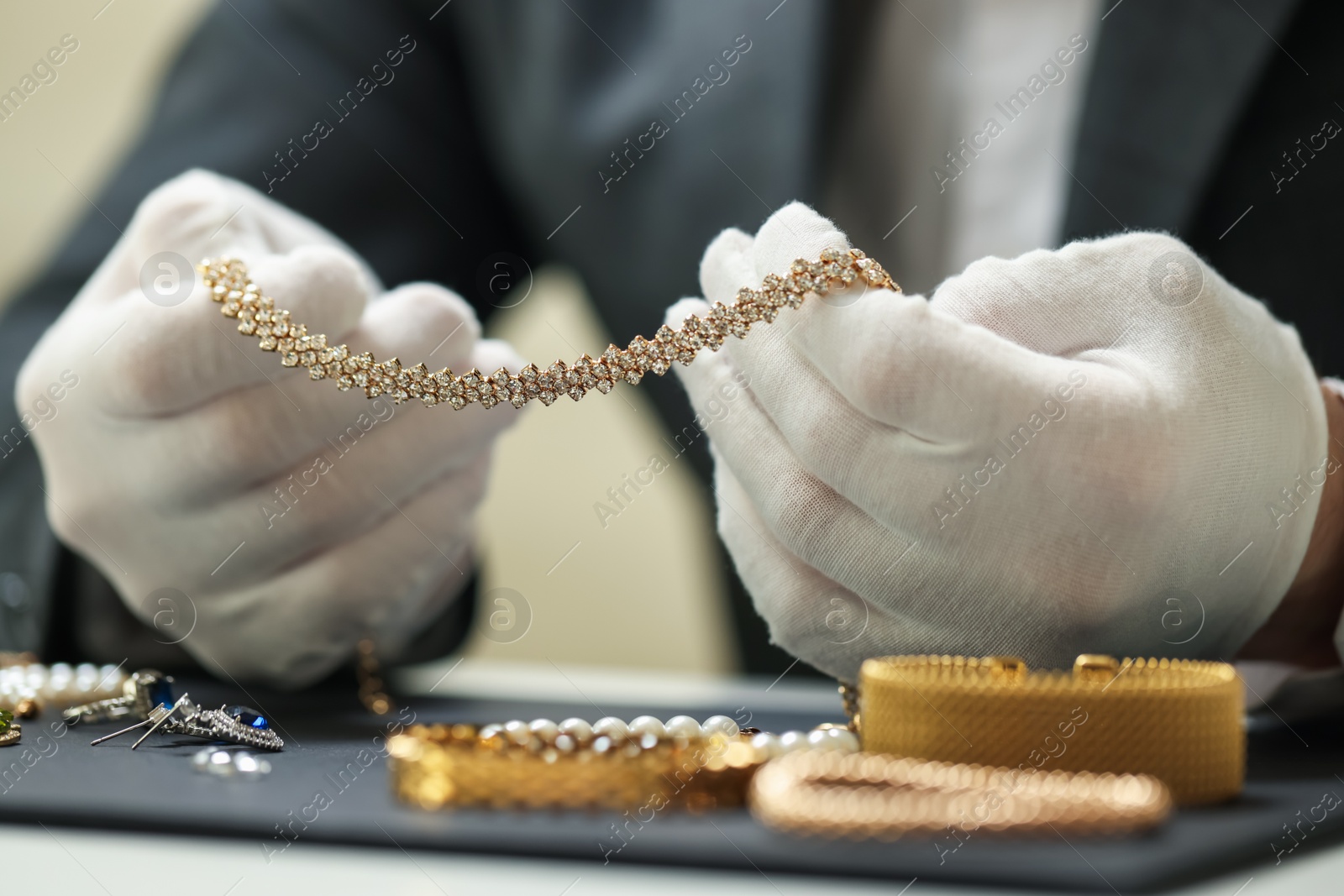 Appraiser working with luxury jewelry at table indoors, closeup Photo of Appraiser working with luxury jewelry at table indoors, closeup