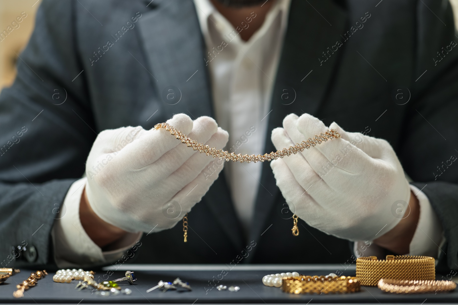 Appraiser working with luxury jewelry at table indoors, closeup Photo of Appraiser working with luxury jewelry at table indoors, closeup