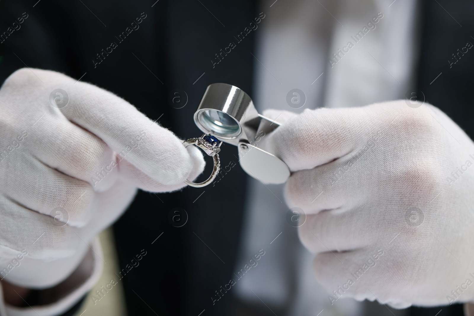 Appraiser with loupe evaluating luxury ring, closeup Photo of Appraiser with loupe evaluating luxury ring, closeup