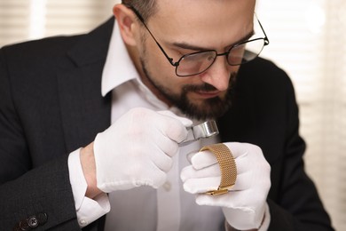 Photo of Appraiser with loupe evaluating luxury bracelet indoors