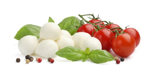 Photo of Tasty mozzarella cheese balls, tomatoes, peppercorns and basil isolated on white