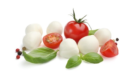 Photo of Tasty mozzarella cheese balls, tomatoes, peppercorns and basil isolated on white