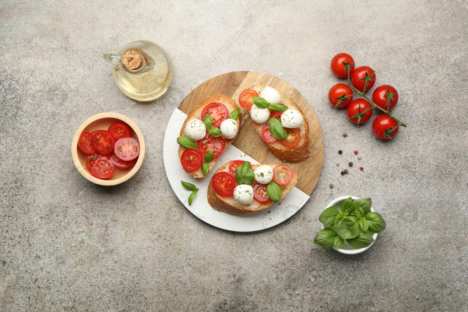 Tasty sandwiches with mozzarella cheese balls, tomato and basil on grey table, flat lay Photo of Tasty sandwiches with mozzarella cheese balls, tomato and basil on grey table, flat lay