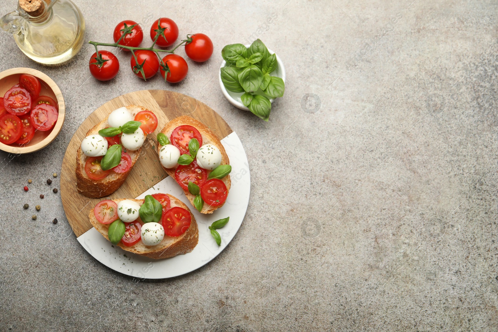 Tasty sandwiches with mozzarella cheese balls, tomato and basil on grey table, flat lay. Space for text Photo of Tasty sandwiches with mozzarella cheese balls, tomato and basil on grey table, flat lay. Space for text