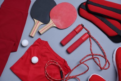 Photo of Flat lay composition with sportswear on grey background