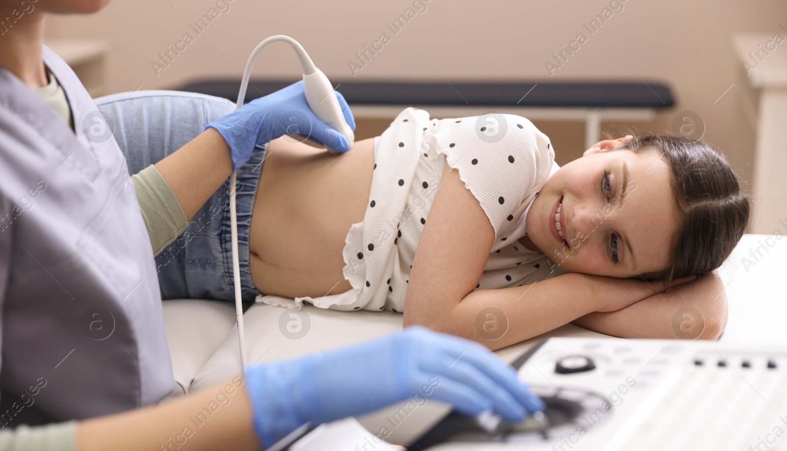 Sonographer conducting girl's renal ultrasound examination in clinic, closeup Photo of Sonographer conducting girl's renal ultrasound examination in clinic, closeup