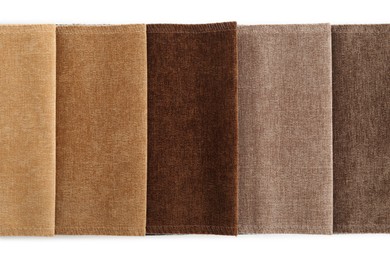 Photo of Samples of different fabrics isolated on white, top view