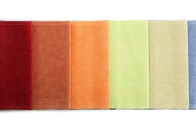 Photo of Samples of different fabrics isolated on white, top view