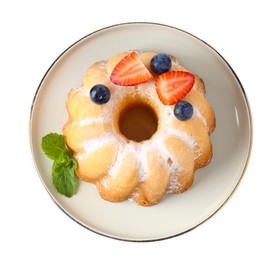 Photo of Tasty Bundt cake with powdered sugar and berries isolated on white, top view