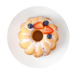 Photo of Tasty Bundt cake with powdered sugar and berries isolated on white, top view