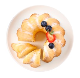 Photo of Tasty bundt cake with powdered sugar and berries isolated on white, top view