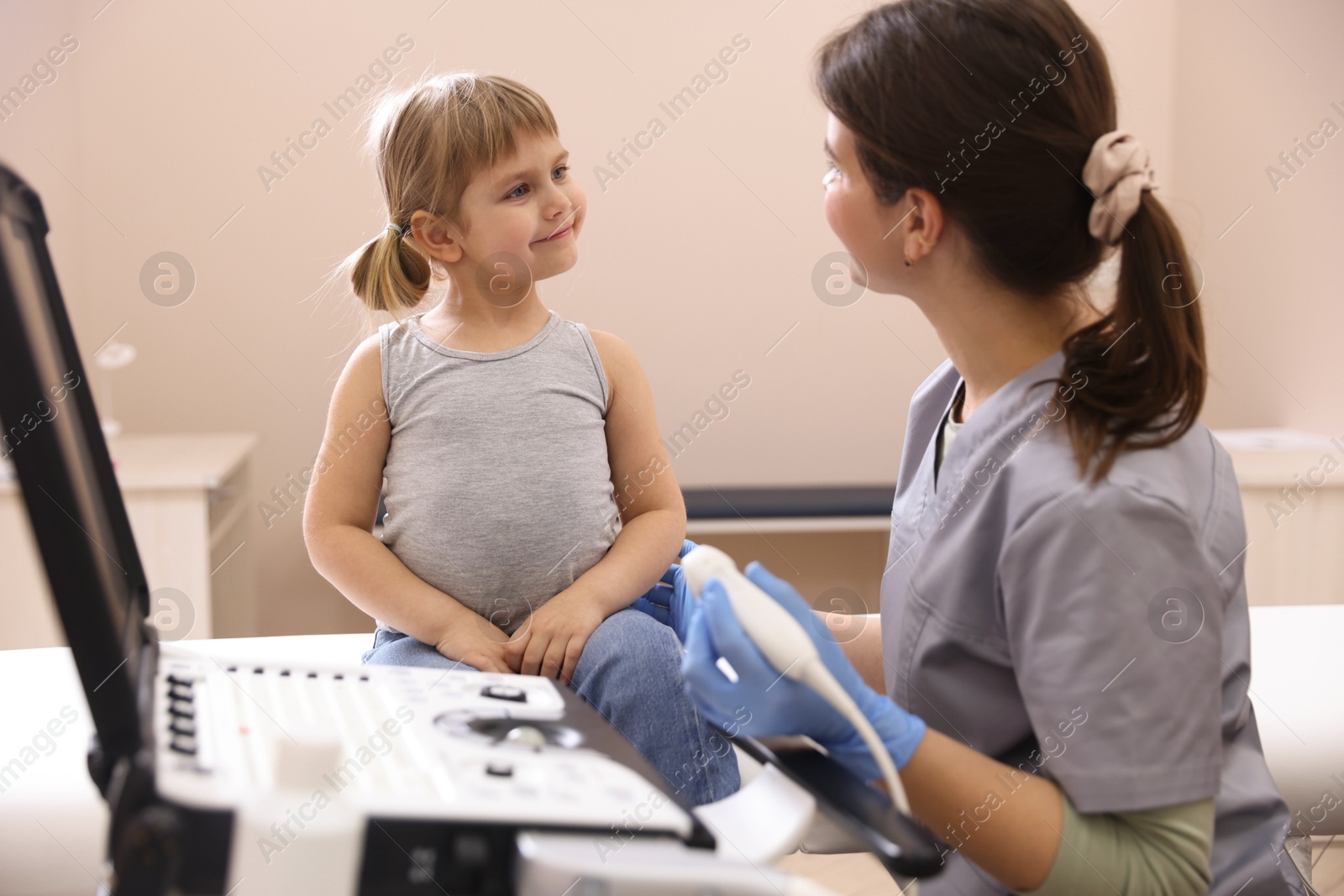 Sonographer conducting little girl's ultrasound examination in clinic Photo of Sonographer conducting little girl's ultrasound examination in clinic