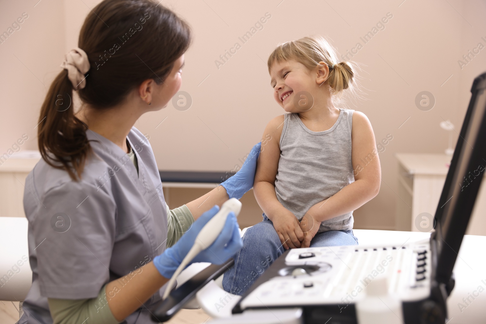 Sonographer conducting little girl's ultrasound examination in clinic Photo of Sonographer conducting little girl's ultrasound examination in clinic