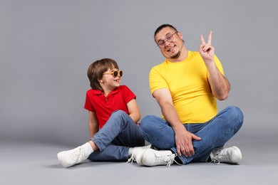 Photo of Father and his son on grey background