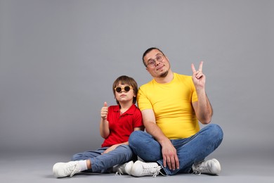 Photo of Father and his son on grey background